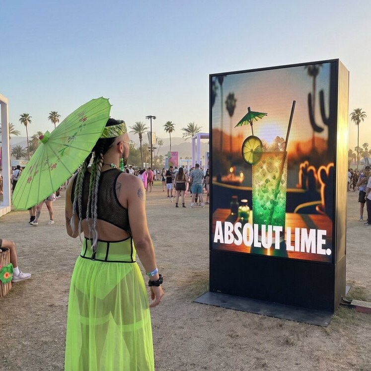 Festival-goer in front of an Absolut Lime cocktail screen at Coachella, Absolut Human Cocktails