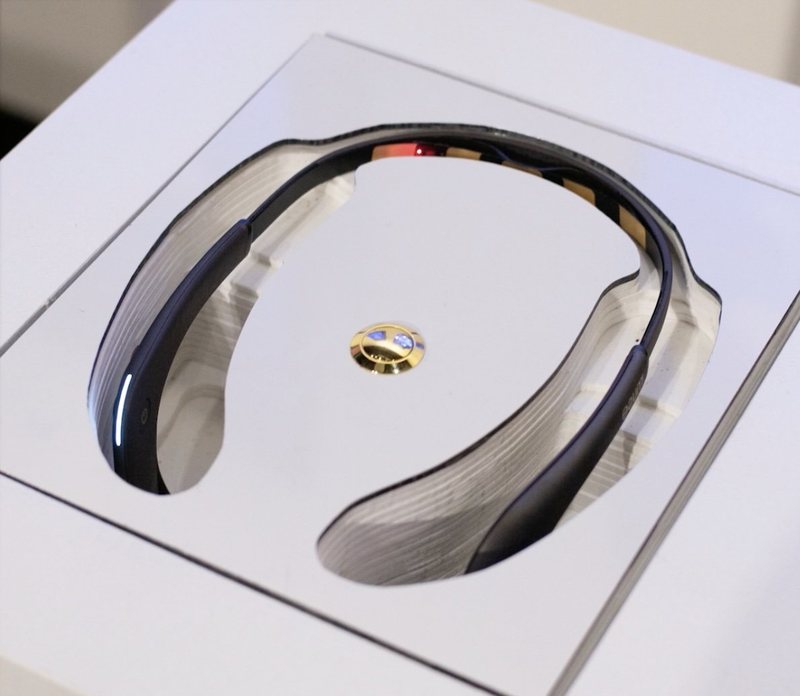 EEG headset displayed in a white plinth, Brainwave Bloom
