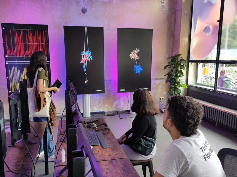 Visitors viewing printed brainwave artworks at the MX Mind Gallery in Berlin