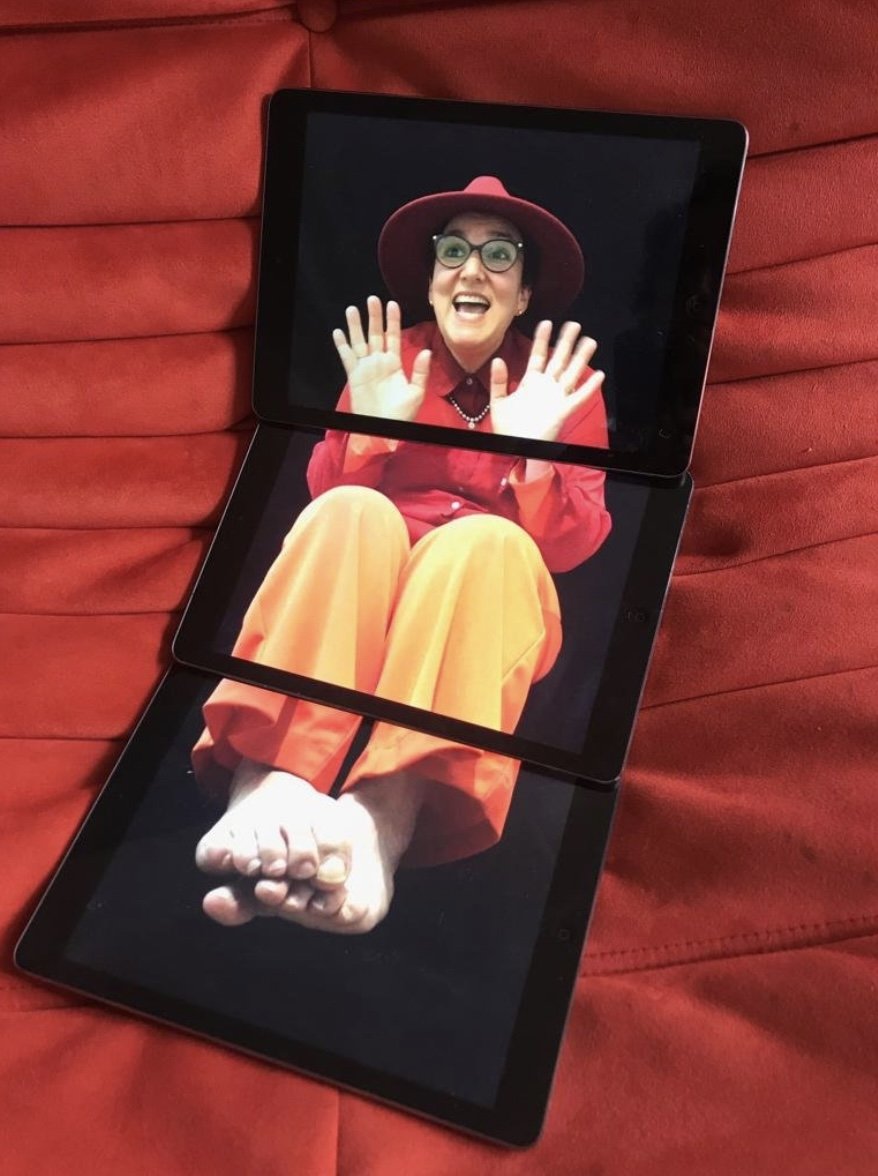 Jesse Wolpert, creative director, appearing on a folding tablet screen